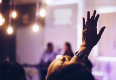 A participant rising hand in an event hosted at One&Co co-working office.